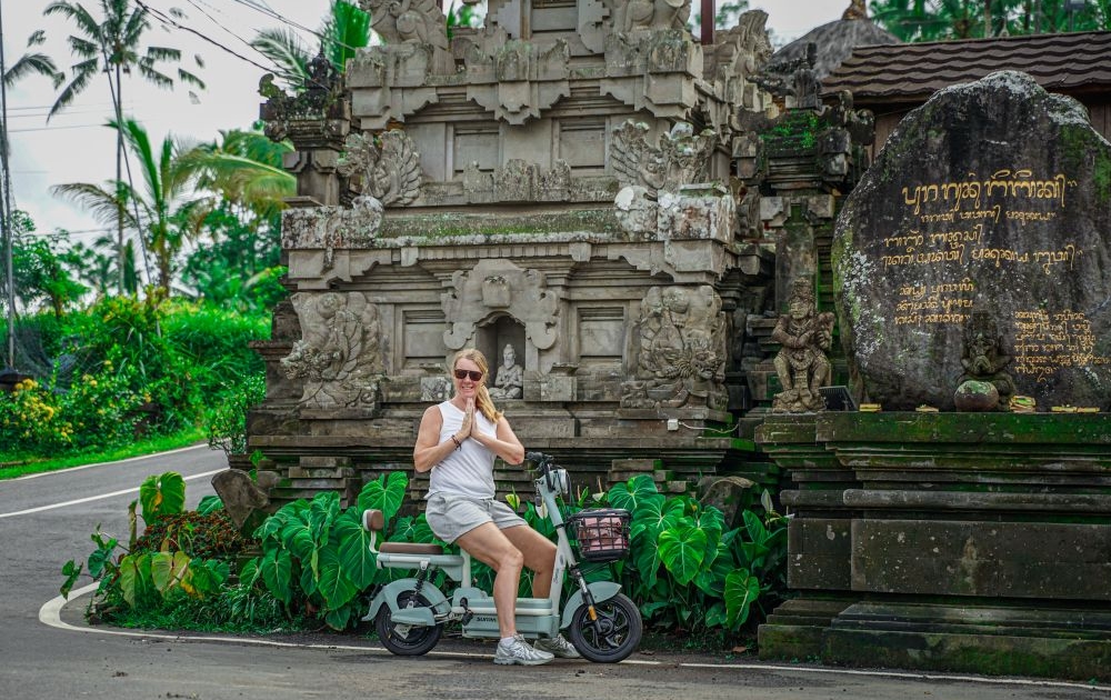 Girl outside Balinese Temple during Ebike tour in Ubud Bali