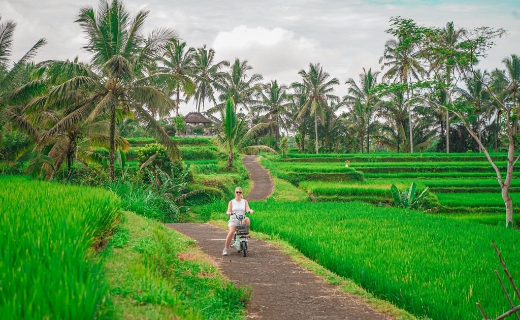 Girl riding Ebike during guided cycling tour in Ubud Bali