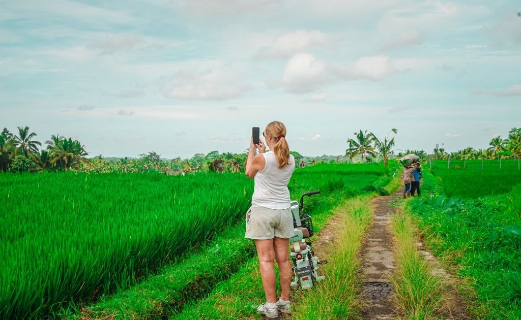 Girl taking photo of rice fields in Ubud Bali
