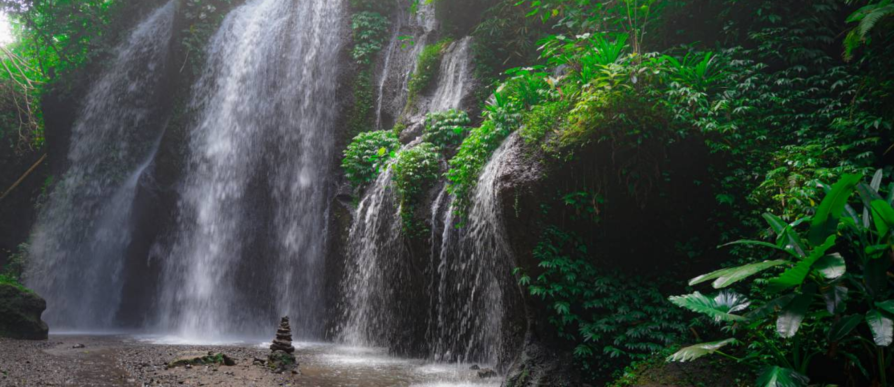 Peaceful Waterfall surrounded by lush green jungle near Ubud Bali